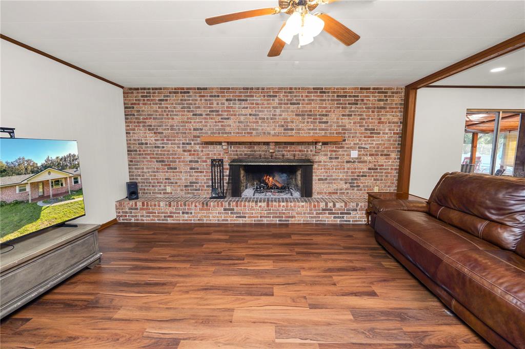 4615 Old Polk City Road Lakeland, FL 33809 - Photo 22 of 71 a living room with furniture and a fireplace