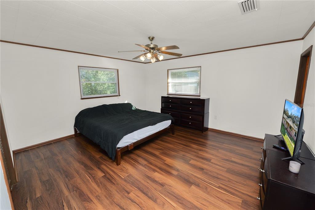 4615 Old Polk City Road Lakeland, FL 33809 - Photo 25 of 71 a bedroom with a bed and a flat screen tv