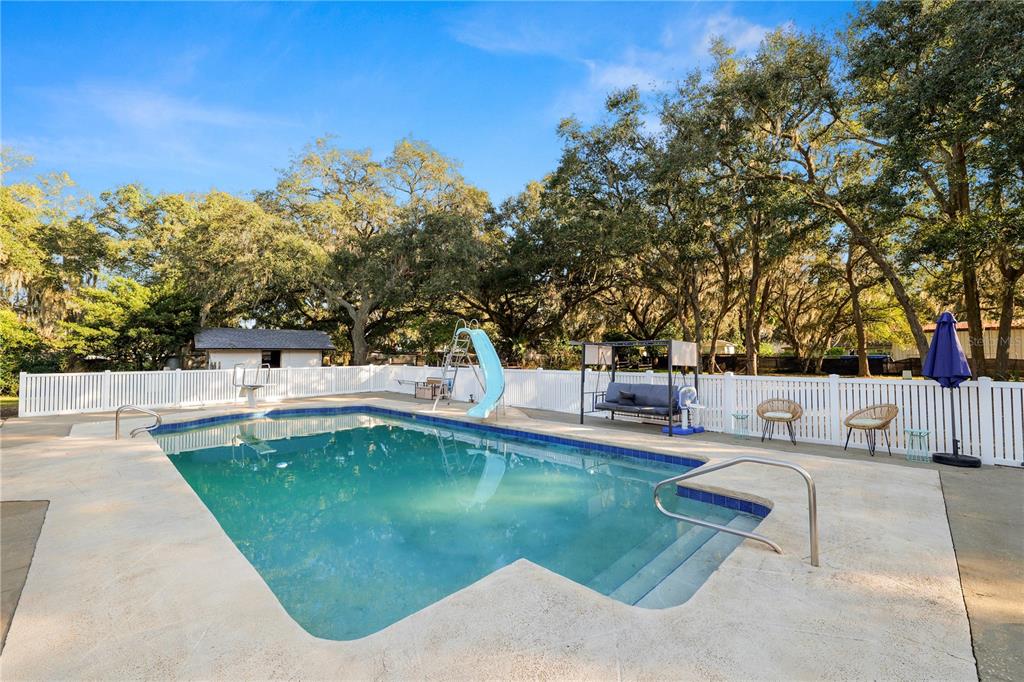 4615 Old Polk City Road Lakeland, FL 33809 - Photo 38 of 71 a view of a swimming pool with a patio