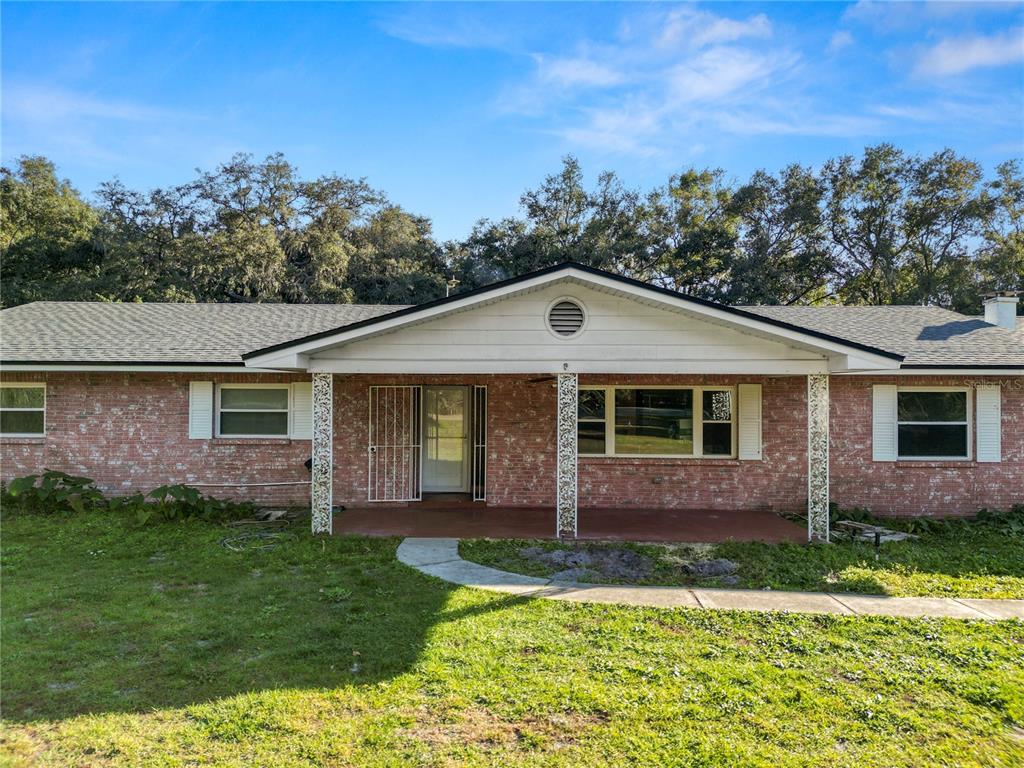 4615 Old Polk City Road Lakeland, FL 33809 - Photo 4 of 71 a front view of a house with a yard and garage