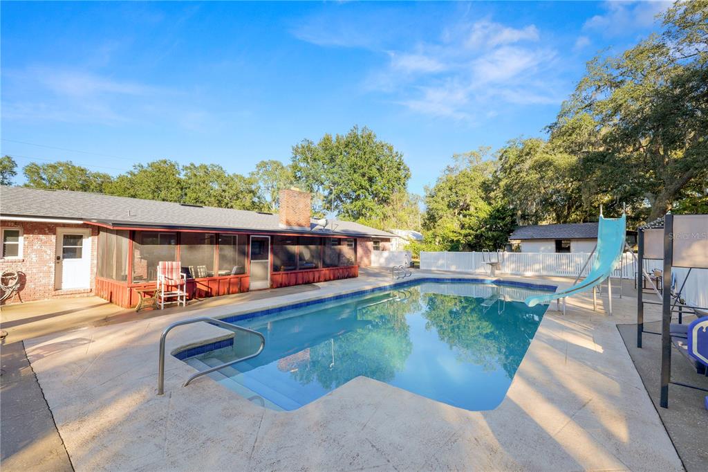 4615 Old Polk City Road Lakeland, FL 33809 - Photo 41 of 71 swimming pool view with a seating space and a garden view