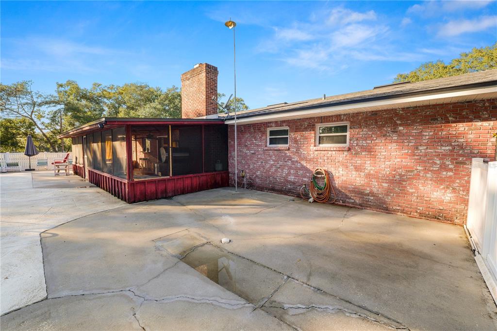 4615 Old Polk City Road Lakeland, FL 33809 - Photo 45 of 71 a backyard of a house with table and chairs
