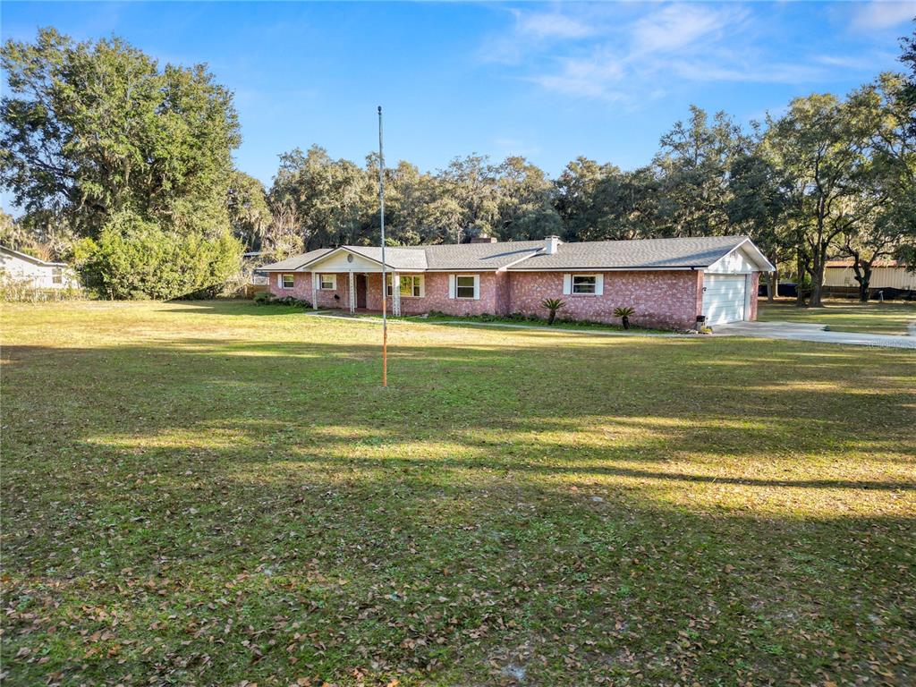 4615 Old Polk City Road Lakeland, FL 33809 - Photo 59 of 71 a front view of a house with a garden