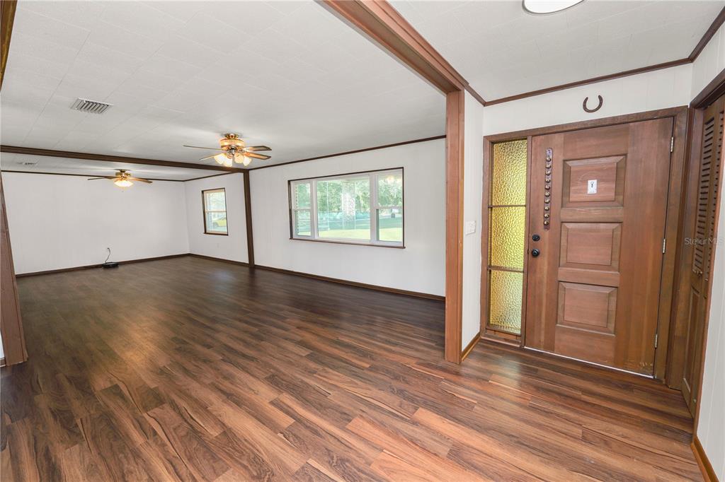 4615 Old Polk City Road Lakeland, FL 33809 - Photo 6 of 71 a view of an empty room with wooden floor and a window