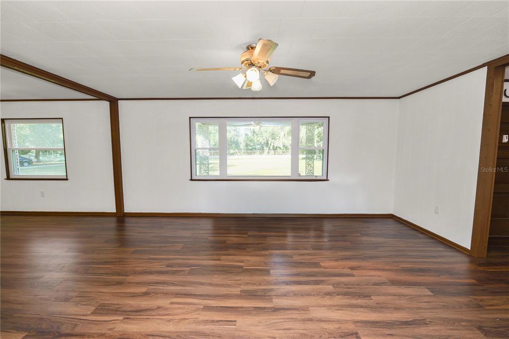 4615 Old Polk City Road Lakeland, FL 33809 - Photo 10 of 71 a view of an empty room with wooden floor and a window