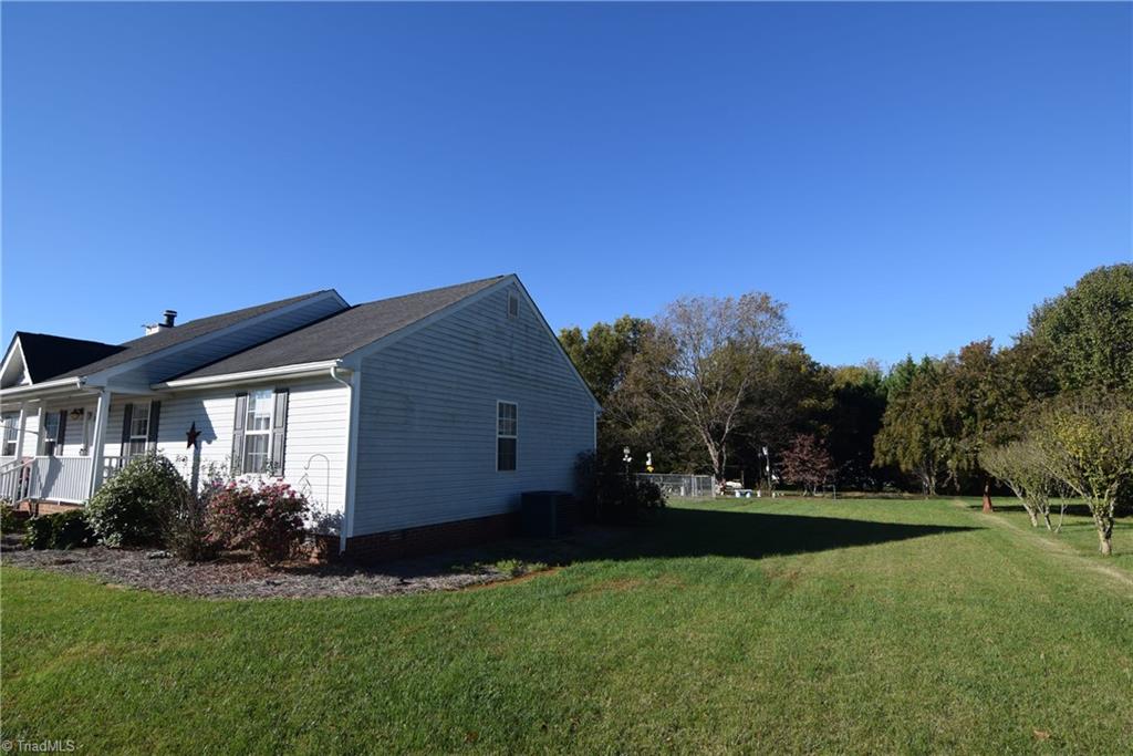 7207 Friendship Church Road Browns Summit, NC 27214 - Photo 41 of 49 Level side yard