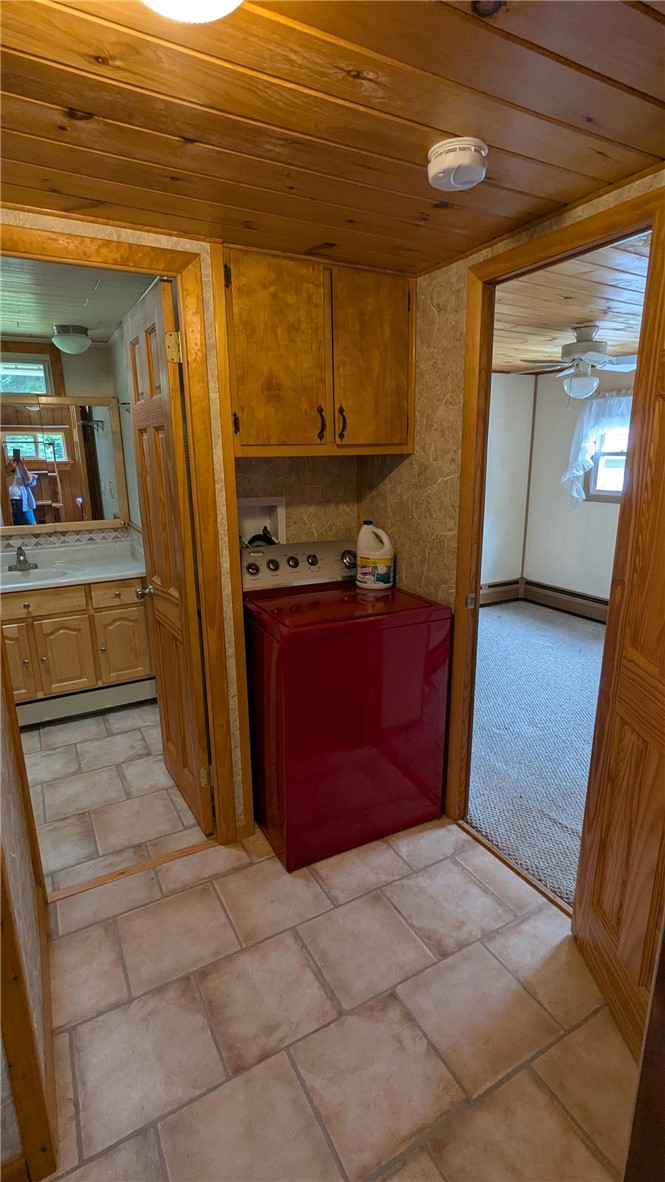 683 Lower 3rd Brook Road Walton, NY 13856 - Photo 20 of 27 Washer located in rear area across from laundry room with dryer. Home is finished with tongue and grove pine on ceilings, great natural trim thru out.