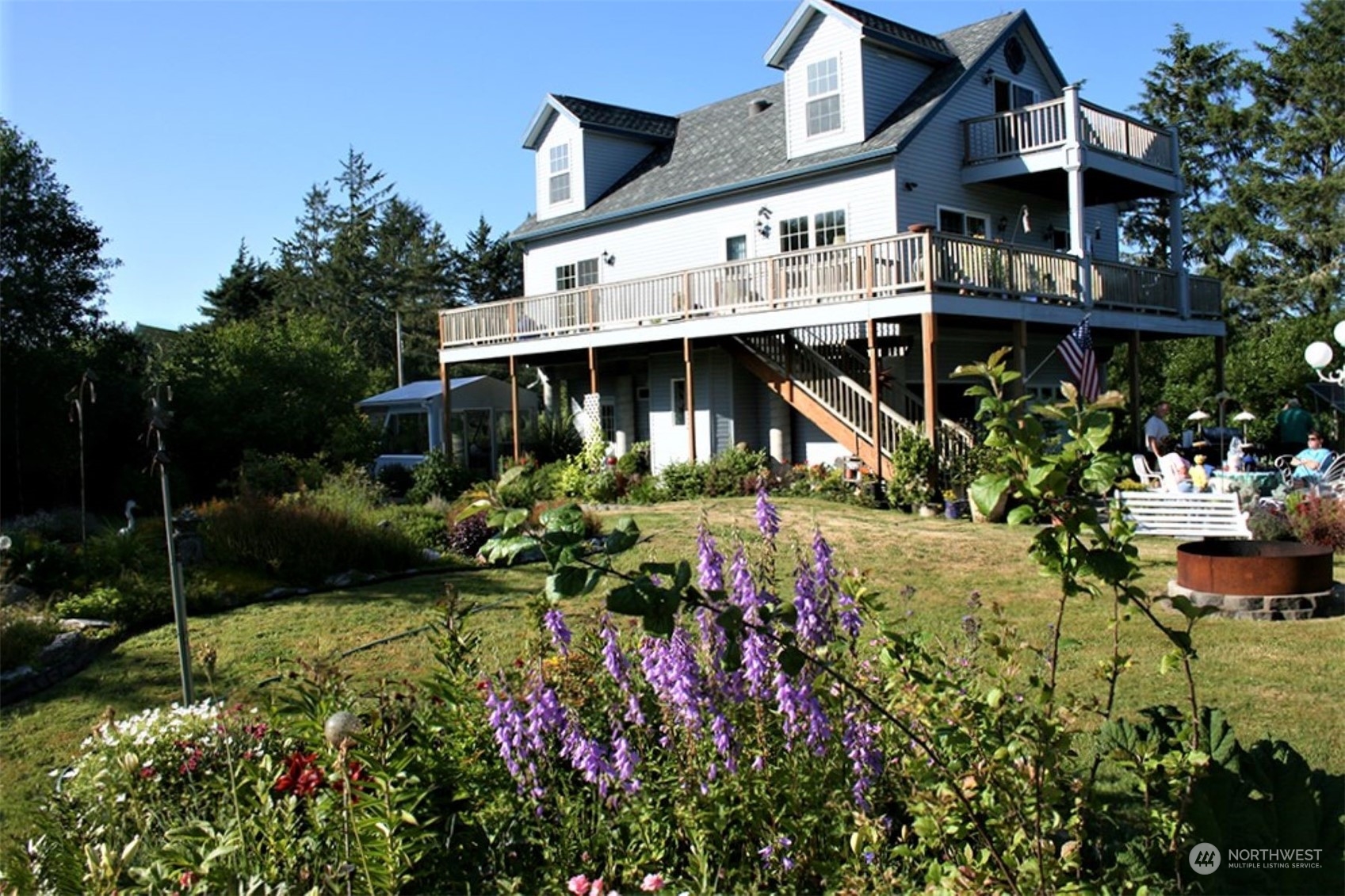 11 Condra Road Copalis Beach, WA 98535 - Photo 3 of 24 a view of a house with a big yard and potted plants