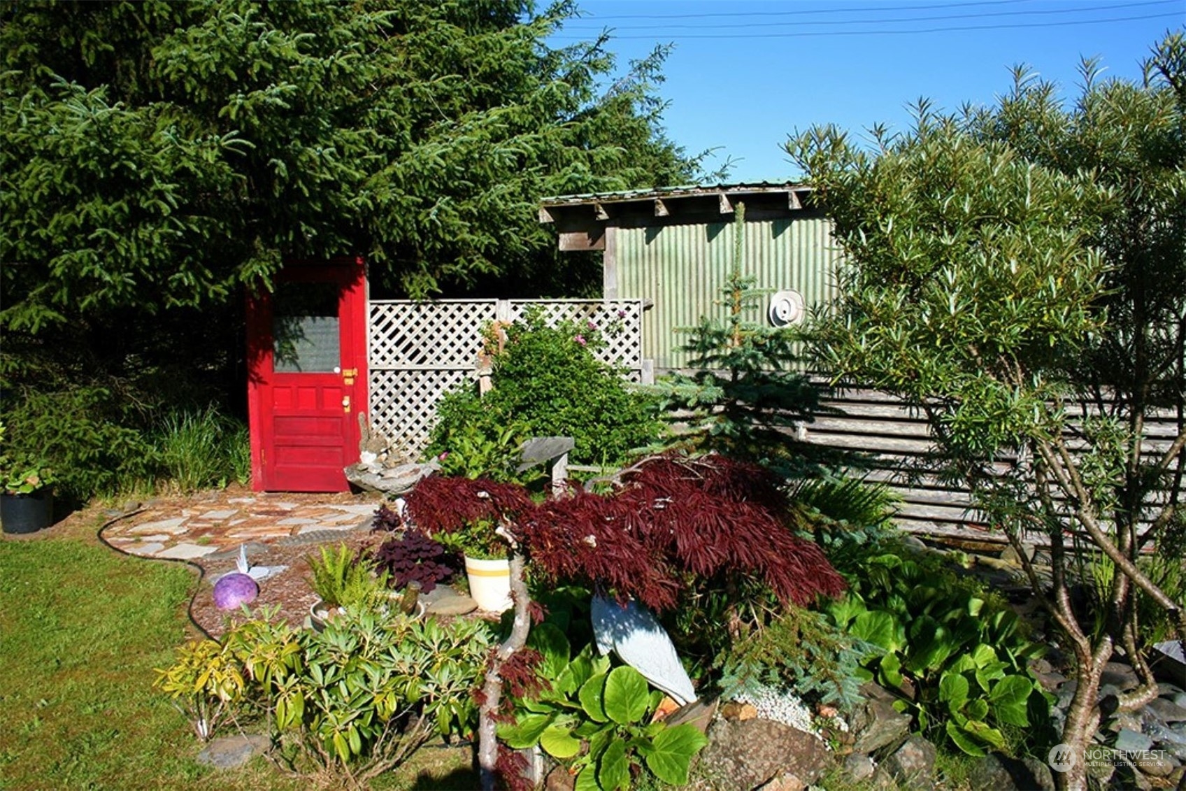 11 Condra Road Copalis Beach, WA 98535 - Photo 5 of 24 a backyard of a house with lots of green space and a fountain