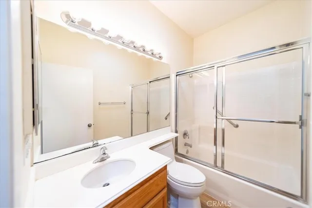 a bathroom with a sink mirror toilet and shower