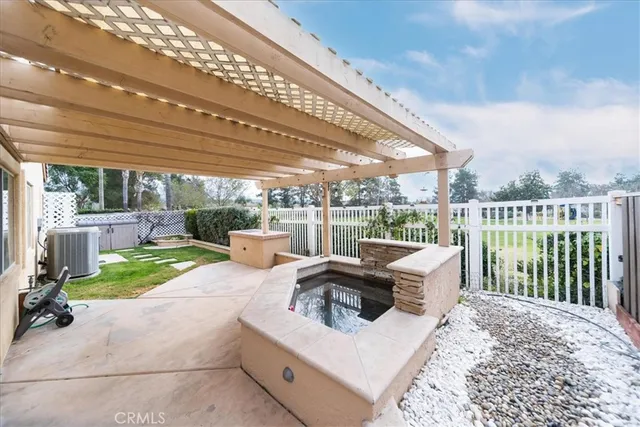 a living room with patio furniture and a floor to ceiling window