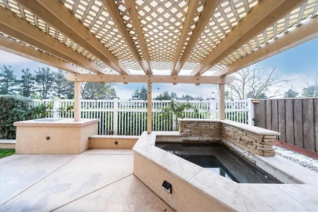 a view of roof deck with couches and wooden fence