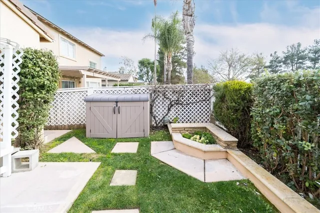 a view of a chair and table in the garden