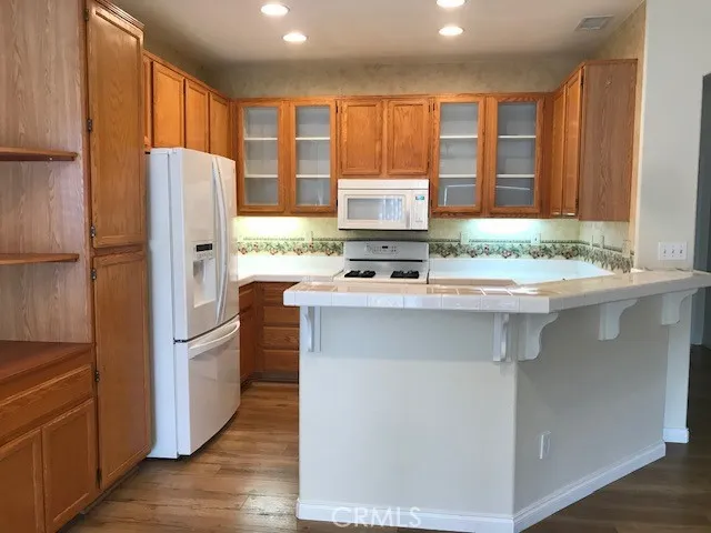 a kitchen with stainless steel appliances granite countertop a refrigerator and a stove