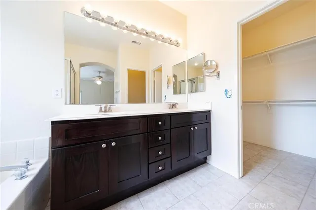 a bathroom with a double vanity sink and mirror