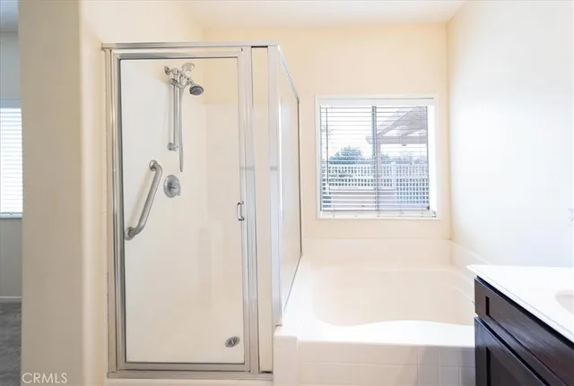 a bathroom with a bathtub and a shower