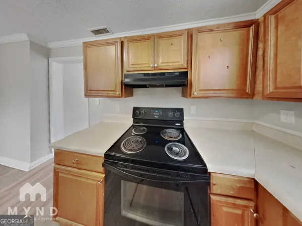 a stove top oven sitting inside of a kitchen