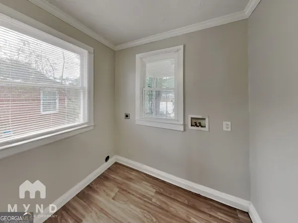a view of a room with wooden floor and windows