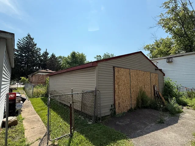 a view of backyard with potted plants and a wooden fence