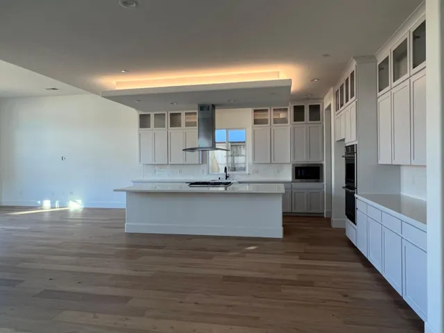 a view of kitchen with cabinets and wooden floor