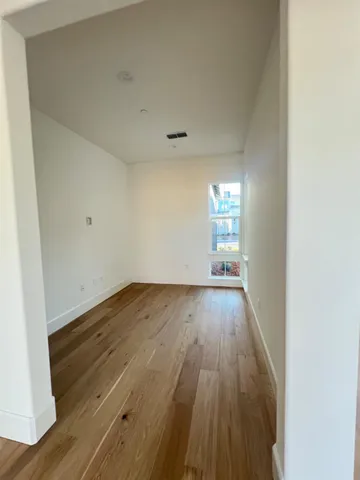 a view of wooden floor and windows in a room