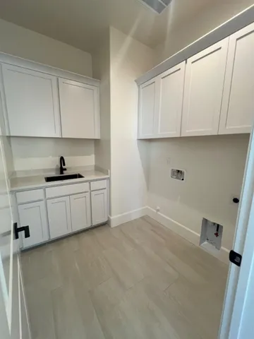 a kitchen with a sink and cabinets