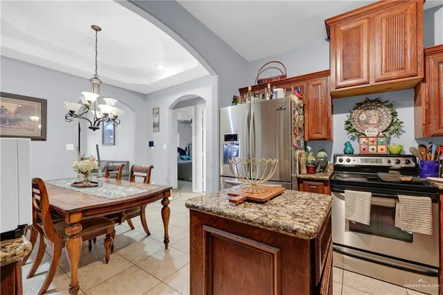 a kitchen with stainless steel appliances granite countertop a stove and a refrigerator