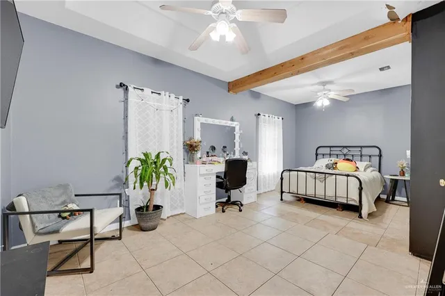 a bedroom with furniture and a chandelier fan