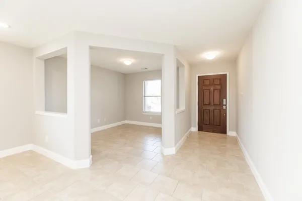 an empty room with windows and closet