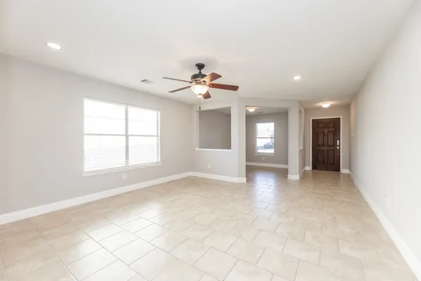 a view of an empty room with window and cabinet