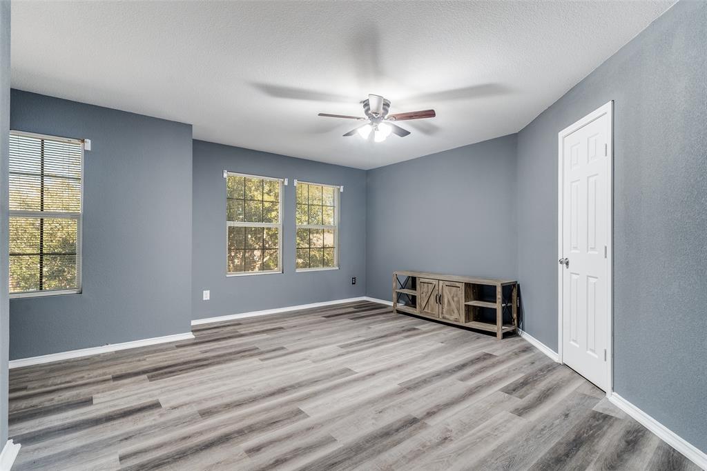 2541 Grand Gulf Road Fort Worth, TX 76123 - Photo 13 of 25 an empty room with windows and chandelier fan