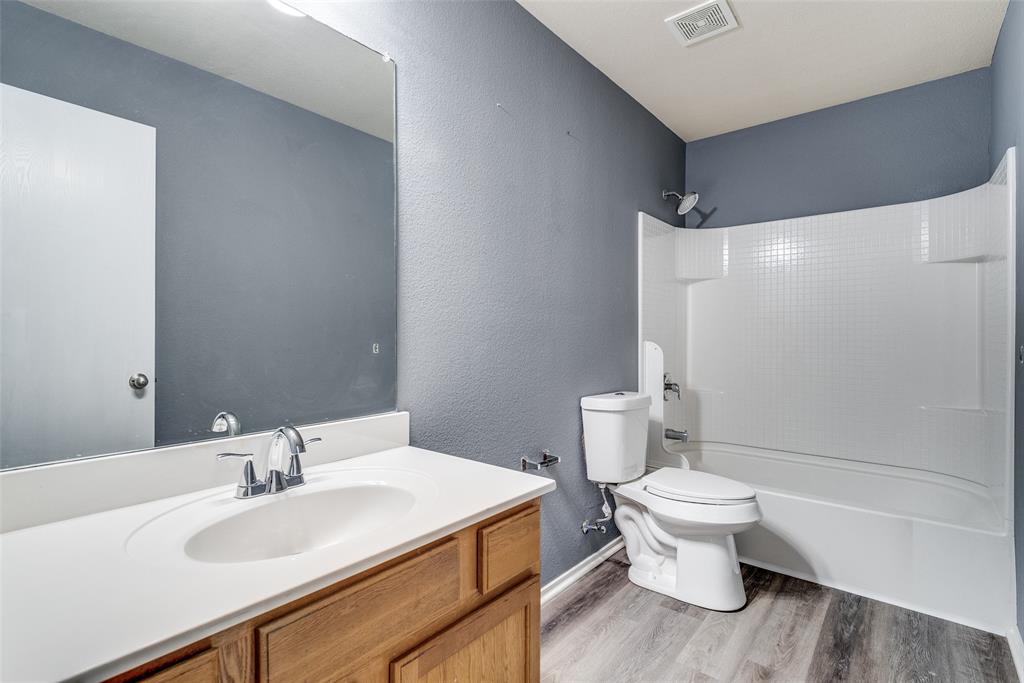 2541 Grand Gulf Road Fort Worth, TX 76123 - Photo 15 of 25 a bathroom with a sink toilet and a mirror
