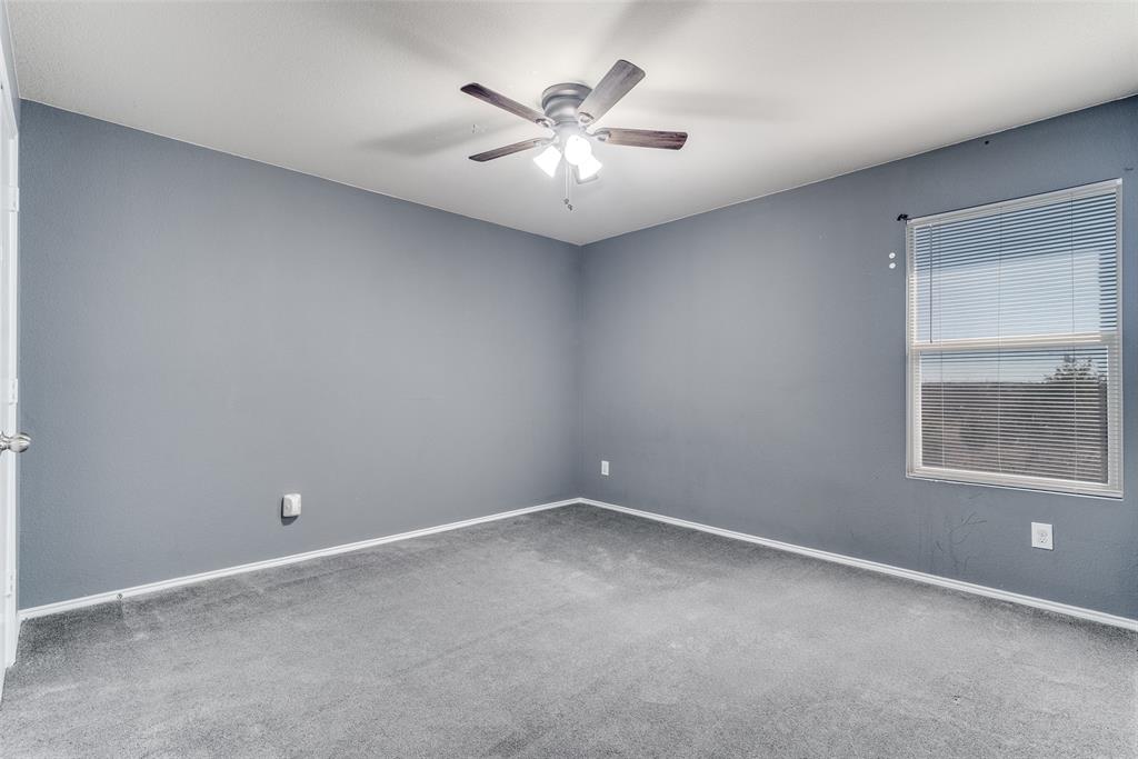 2541 Grand Gulf Road Fort Worth, TX 76123 - Photo 16 of 25 an empty room with a chandelier fan and windows