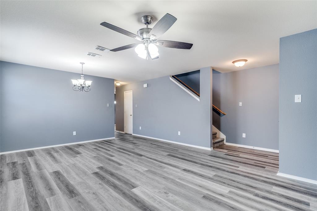 2541 Grand Gulf Road Fort Worth, TX 76123 - Photo 3 of 25 a view of an empty room with wooden floor and a ceiling fan