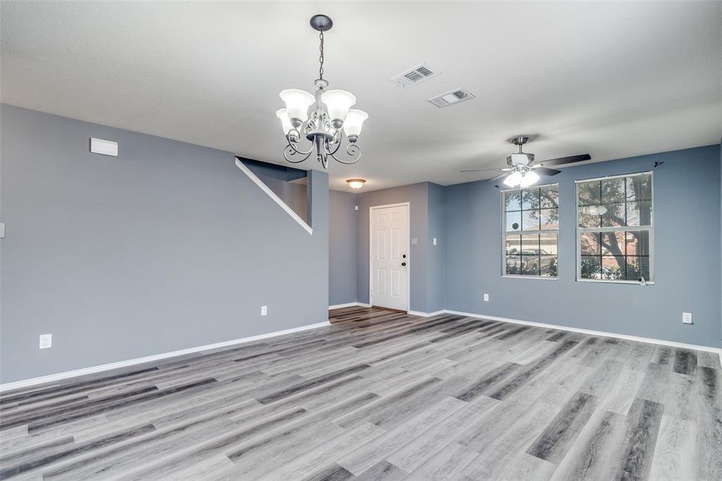 2541 Grand Gulf Road Fort Worth, TX 76123 - Photo 4 of 25 a view of a livingroom with a chandelier fan and windows