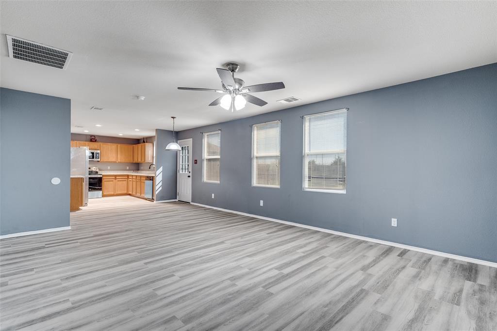 2541 Grand Gulf Road Fort Worth, TX 76123 - Photo 6 of 25 a view of an empty room with a window and wooden floor