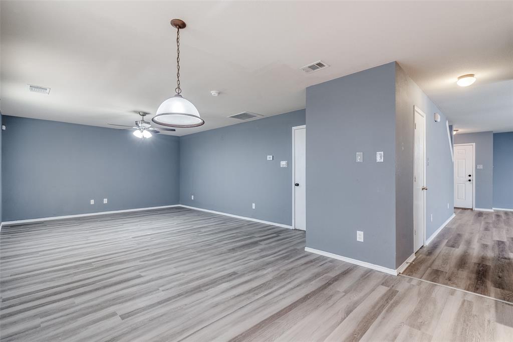 2541 Grand Gulf Road Fort Worth, TX 76123 - Photo 10 of 25 a view of a room with wooden floor and flat screen tv