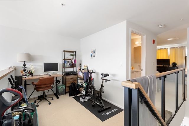 a view of a workspace with furniture and a window