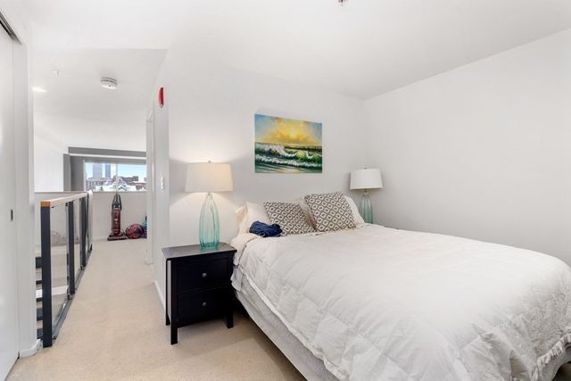 a bedroom with bed and window