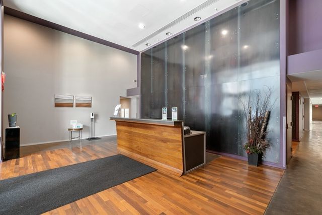 a bedroom with a bed and a large mirror