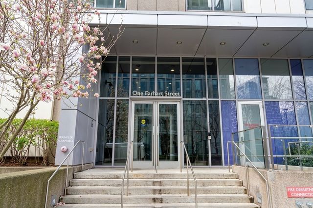 a view of a building with a window and a tree