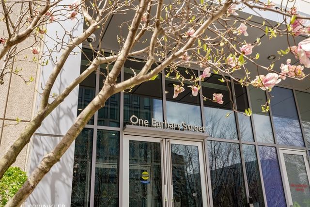 a front view of a house with a tree