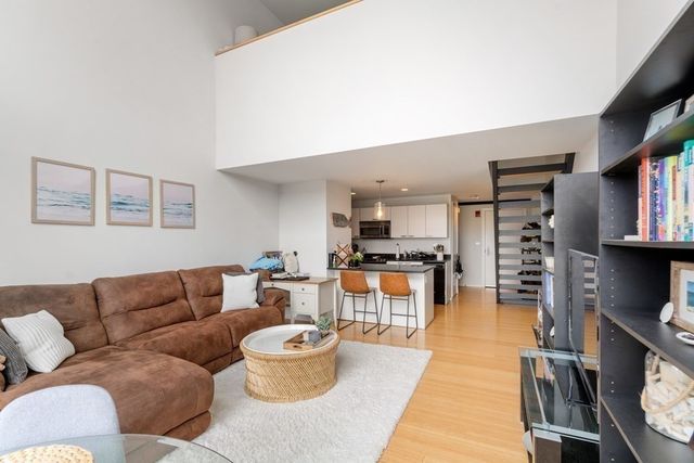 a living room with furniture and a book shelf