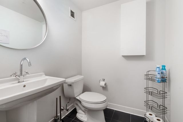a bathroom with a sink toilet and a mirror