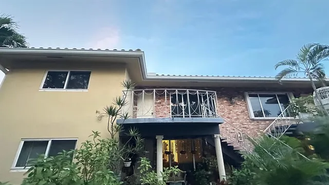 a view of a house with roof and balcony