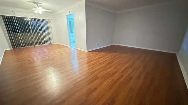 an empty room with wooden floor