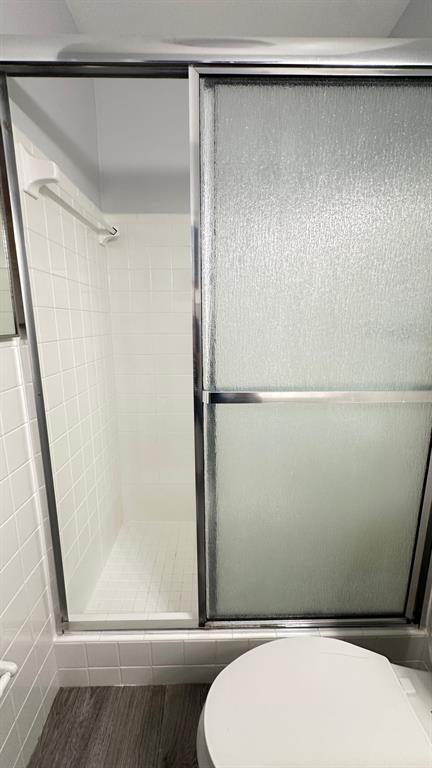 1911 Northeast 28th Court, Unit 2B Lighthouse Point, FL 33064 - Photo 10 of 17 a bathroom with a shower and a toilet