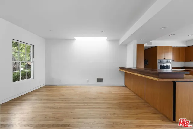 a view of kitchen with sink and wooden floor