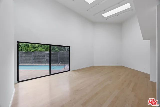an empty room with sliding glass door and windows