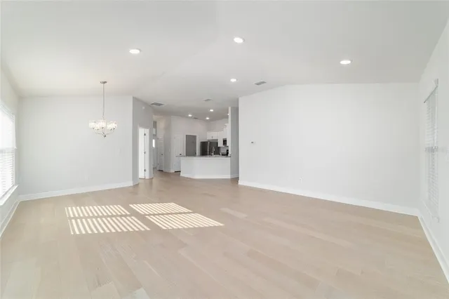 a view of kitchen with refrigerator and microwave